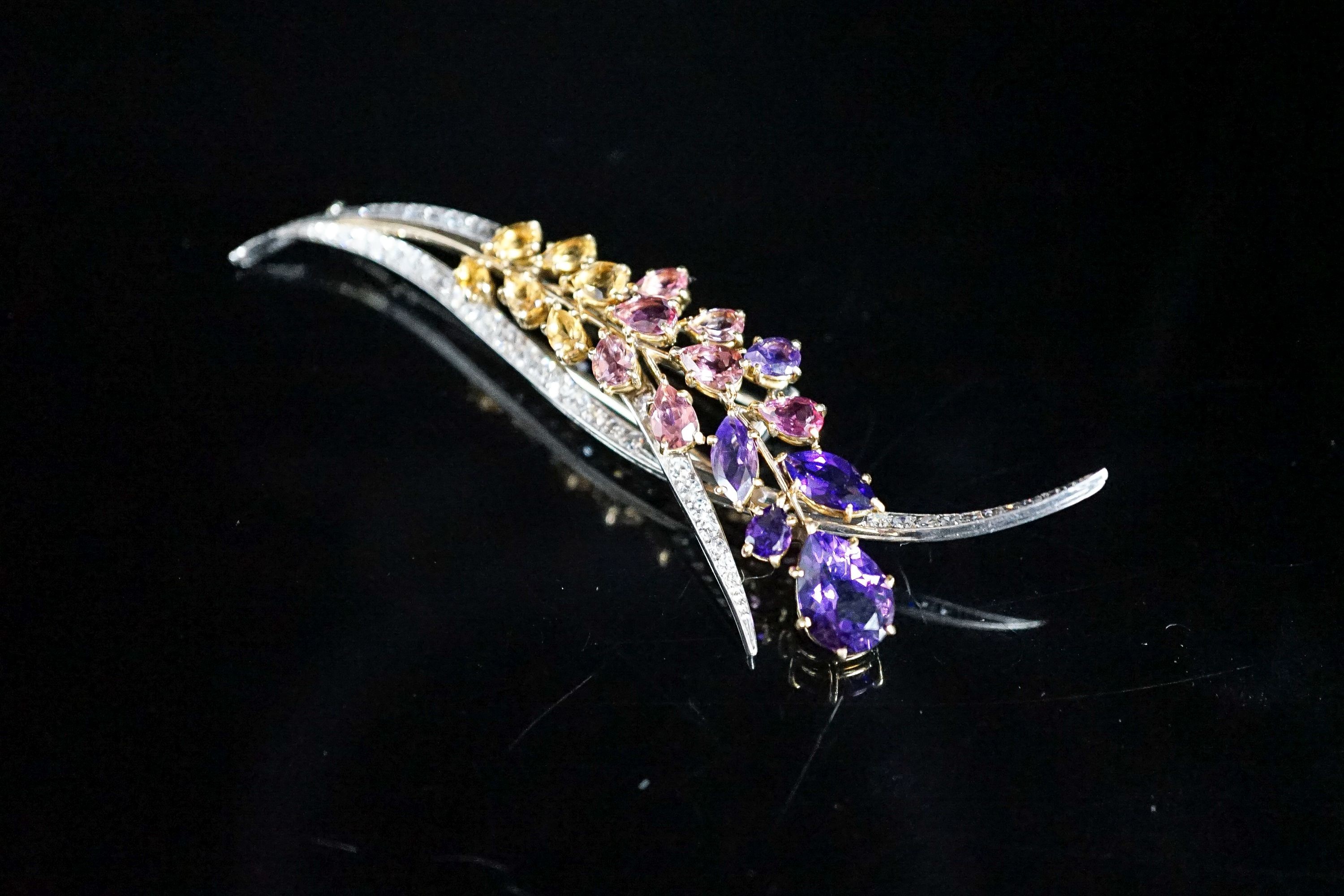 A French 18ct white metal, diamond and multi gem set floral spray brooch, 85mm, gross 17.4 grams.